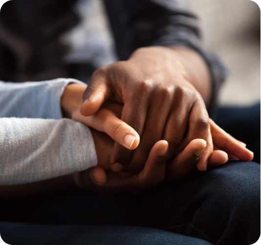 A close up of Two women holding hands