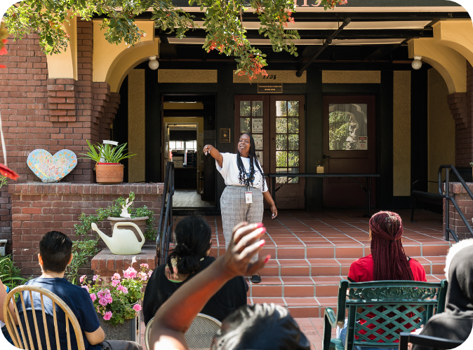 A group of residences at a group therapy session, out front of the ACW residences